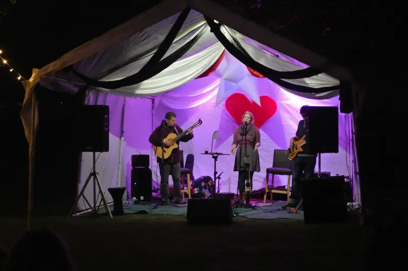 A small stage lit in violet at Magic Orchard on Cowran Estate